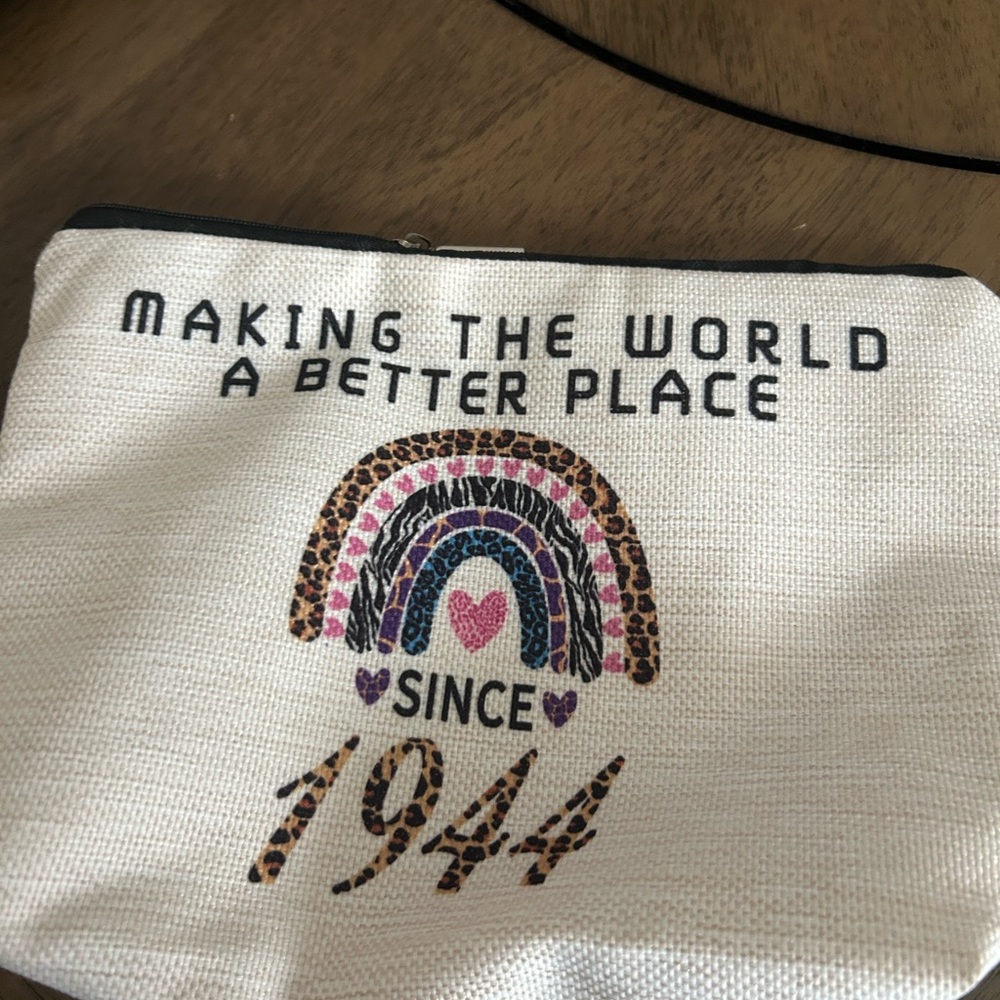 NWOT, Makeup Purse, Says "Making the world a better place since 1944".  10x7.